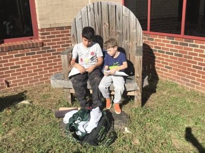 Students read outside in the beautiful fall weather
